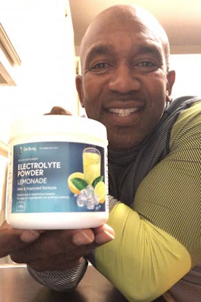 A man with Dr. Berg Electrolyte Powder Lemonade Flavor product 