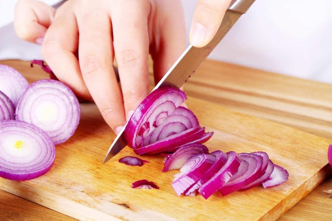 Female hands cutting bulb onion | Easy And Delicious Chicken Tortilla Soup Recipe To Try This Fall | easy chicken tortilla soup recipe