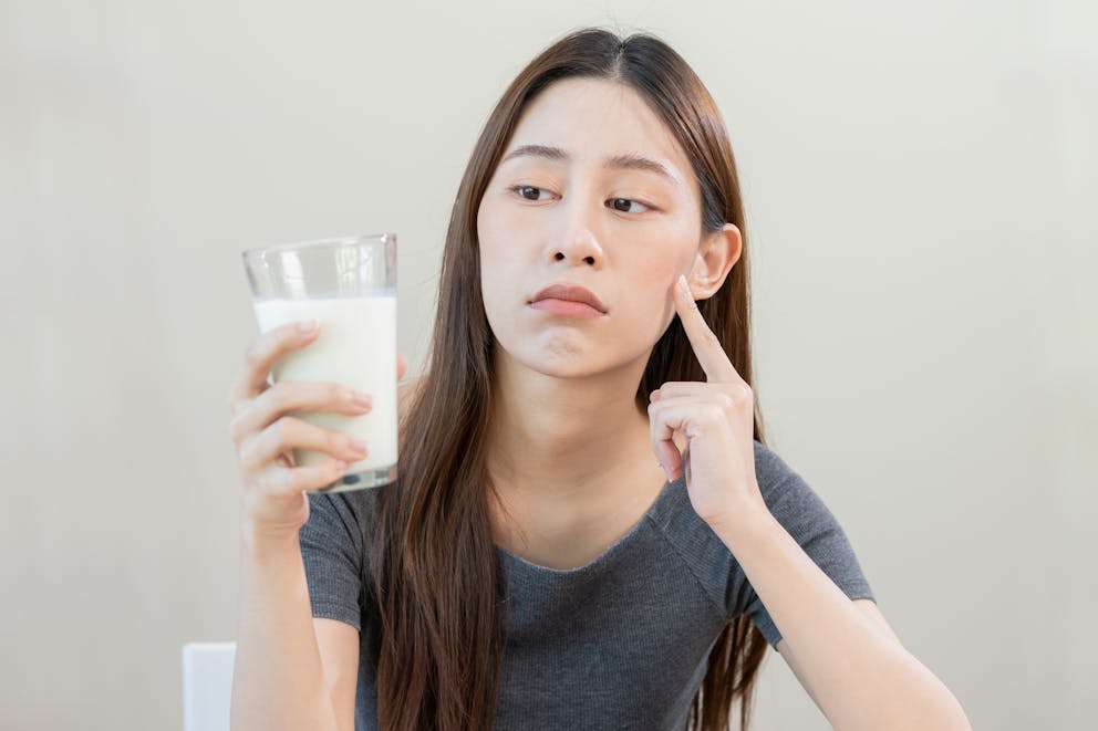 Young woman looking at a glass of milk