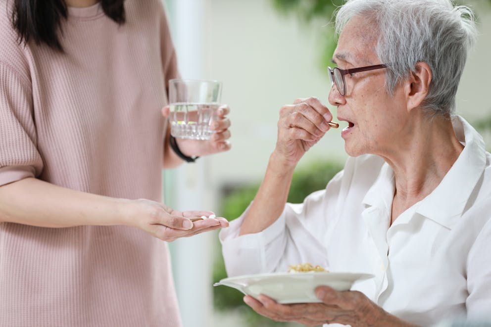 woman taking pill before meal