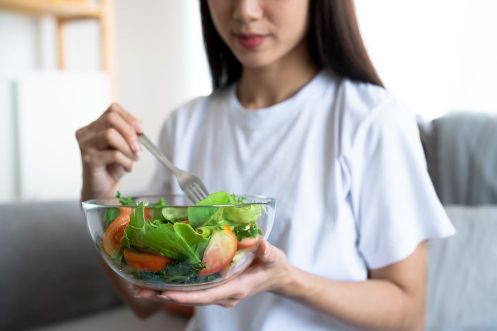 Woman eating a small salad