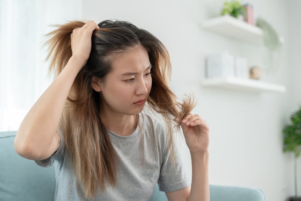 Woman studying hair problem