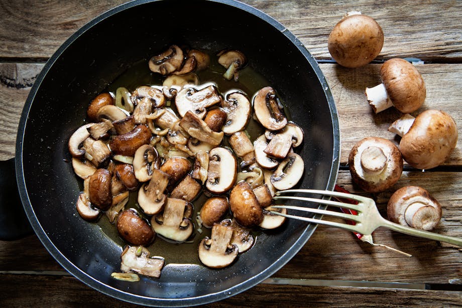 Sliced mushrooms in pan