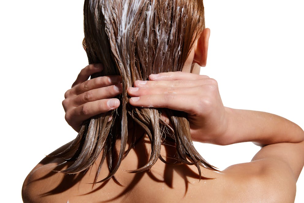 Woman applying hair oil