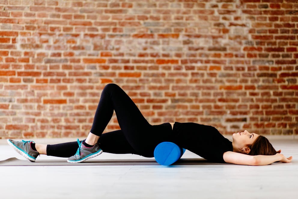 Woman doing foam roller stretch