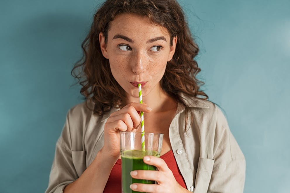 Woman drinking wheatgrass juice
