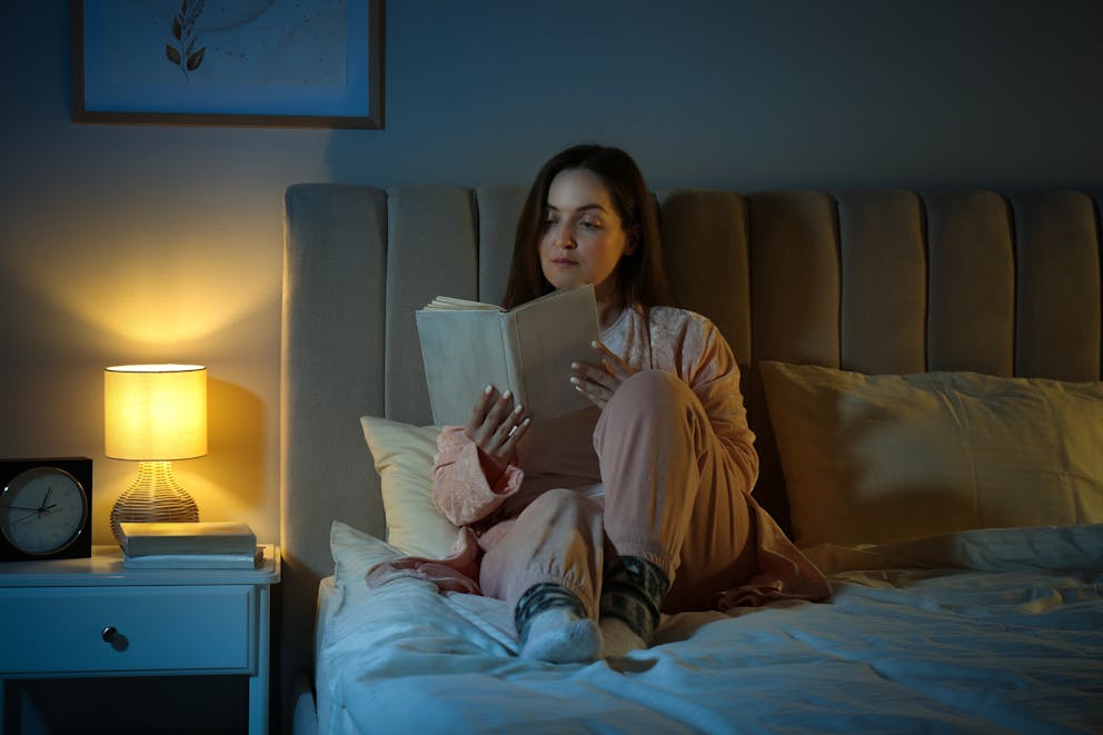 Woman reading under soft lighting