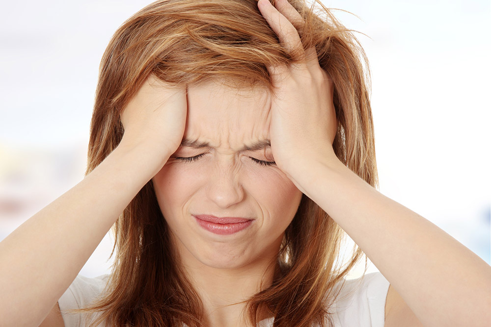 a picture of a stressed-out woman clutching her head