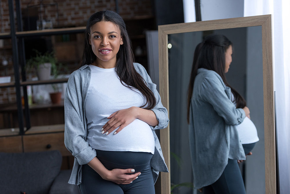 a picture of a pregnant woman of color