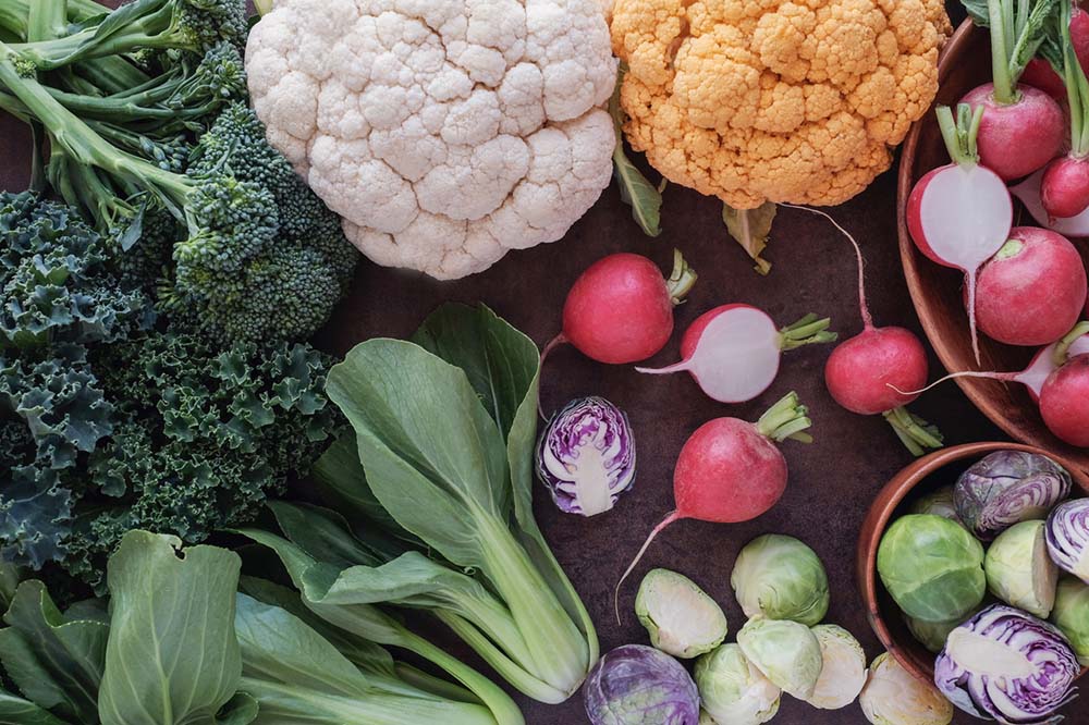 A selection of cruciferous vegetables – kale, broccoli, cauliflower, radishes, Brussel’s sprouts.