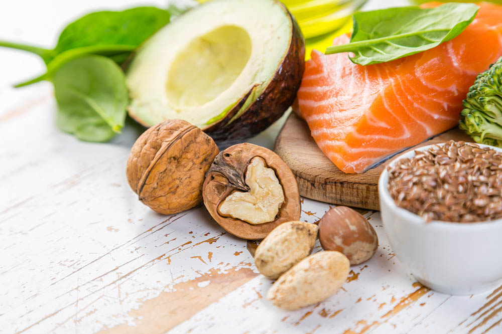 Healthy ketogenic diet fat sources including salmon, avocados, nuts, and flax seed