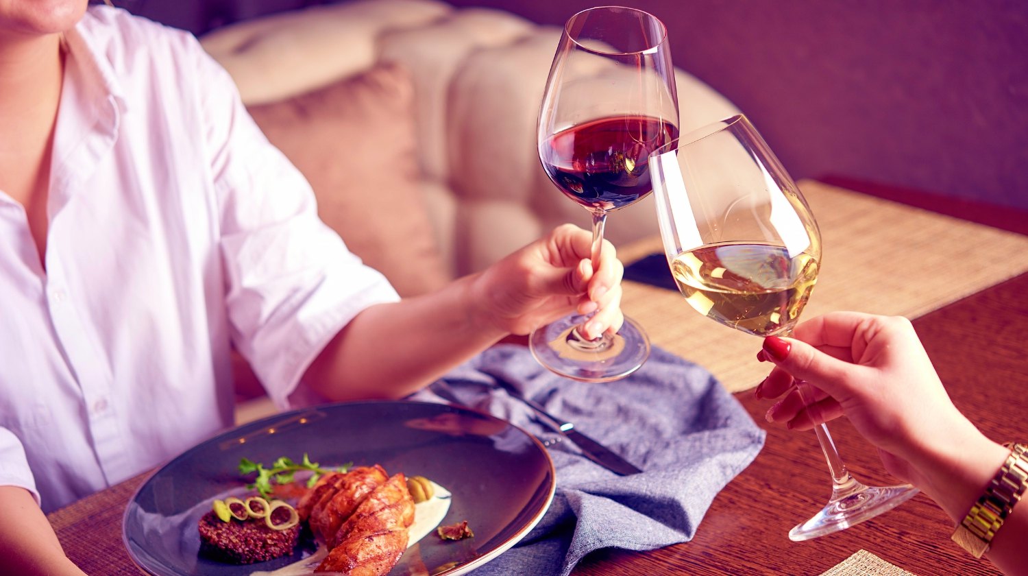 Women eating and drinking red and white wine | Can I Consume Alcohol on KETO Diet?