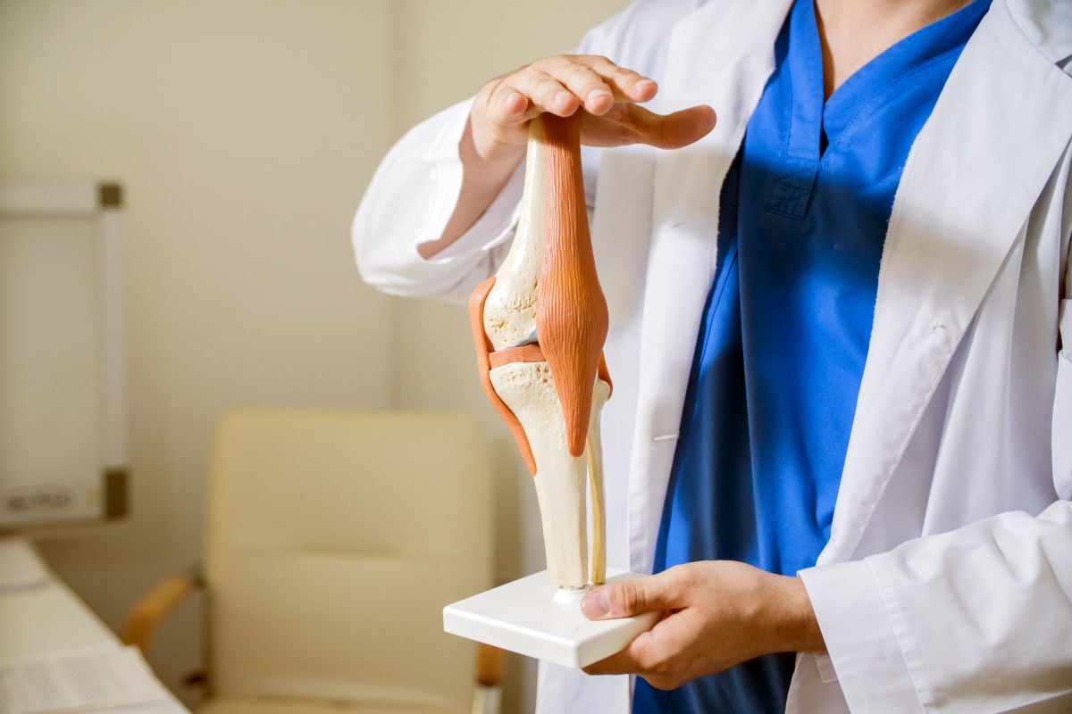 Doctor's hands the layout of the knee joint | The Best Thing To Do If You Have Bone On Bone Knees | Have Bone On Bone Knee | alternatives to knee replacement bone on bone