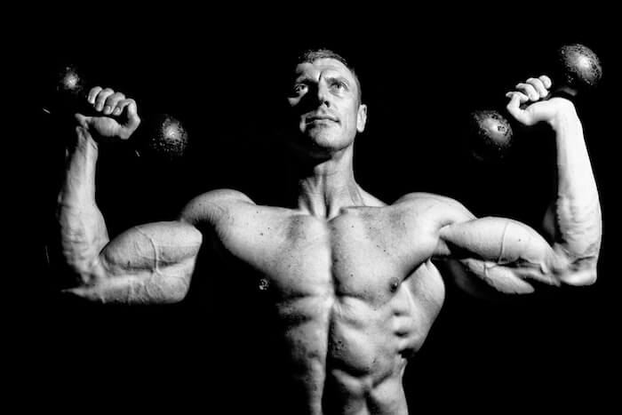 A man lifting weights |  Avoid These 3 Things and Boost Low Testosterone