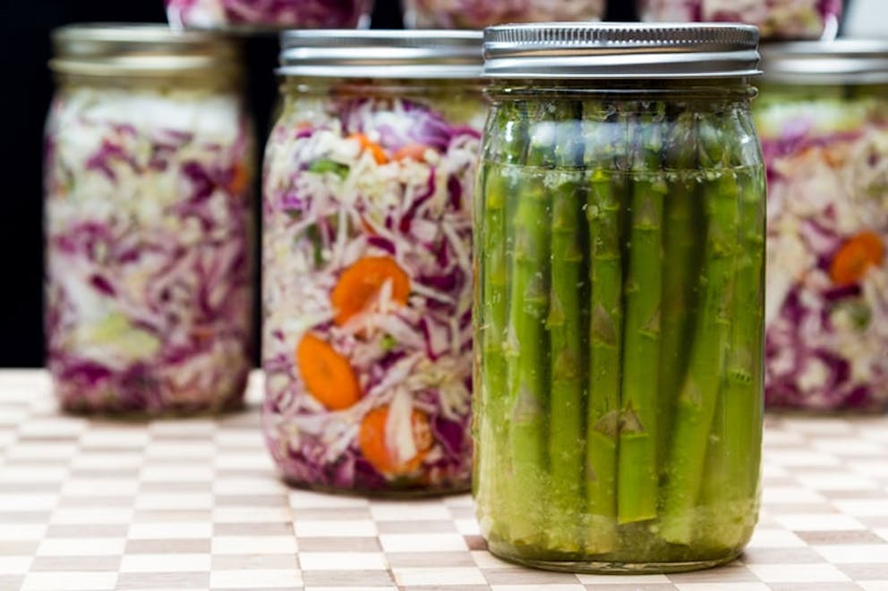 Homemade canned asparagus and sauerkraut, fermented food, healthy probiotic and prebiotic foods.