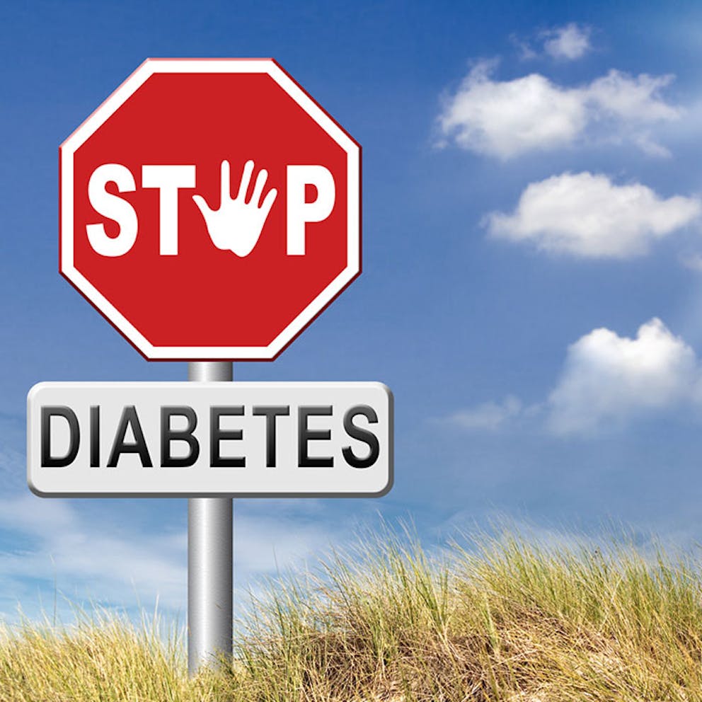 Stop sign with word diabetes beneath it and sky background, concept of diabetes remission and reversal.