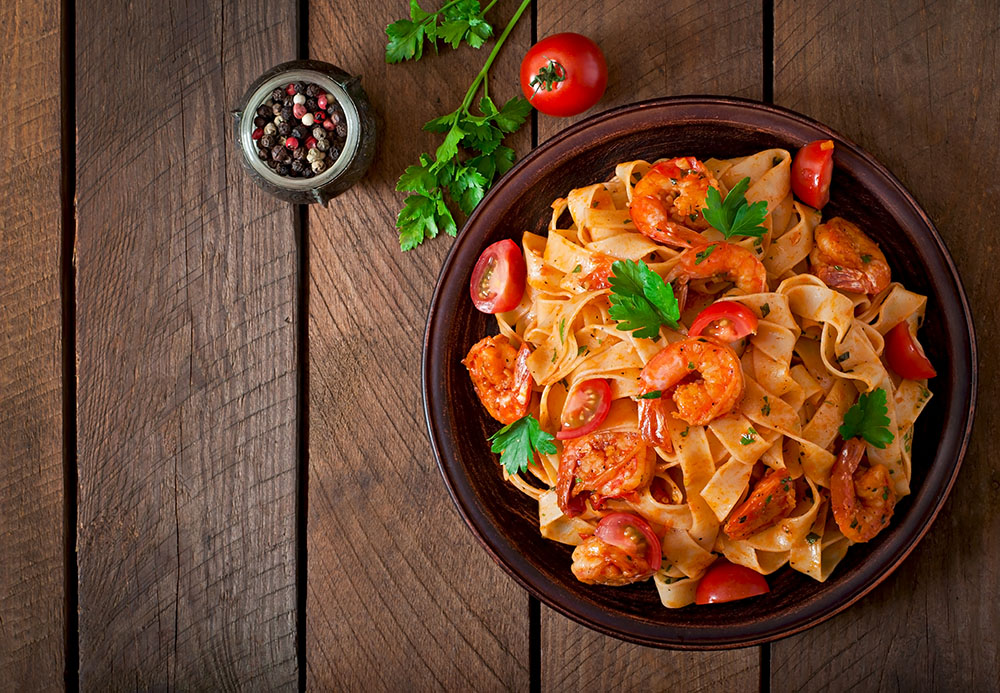 fettuccine pasta with shrimp, tomatoes, and herbs