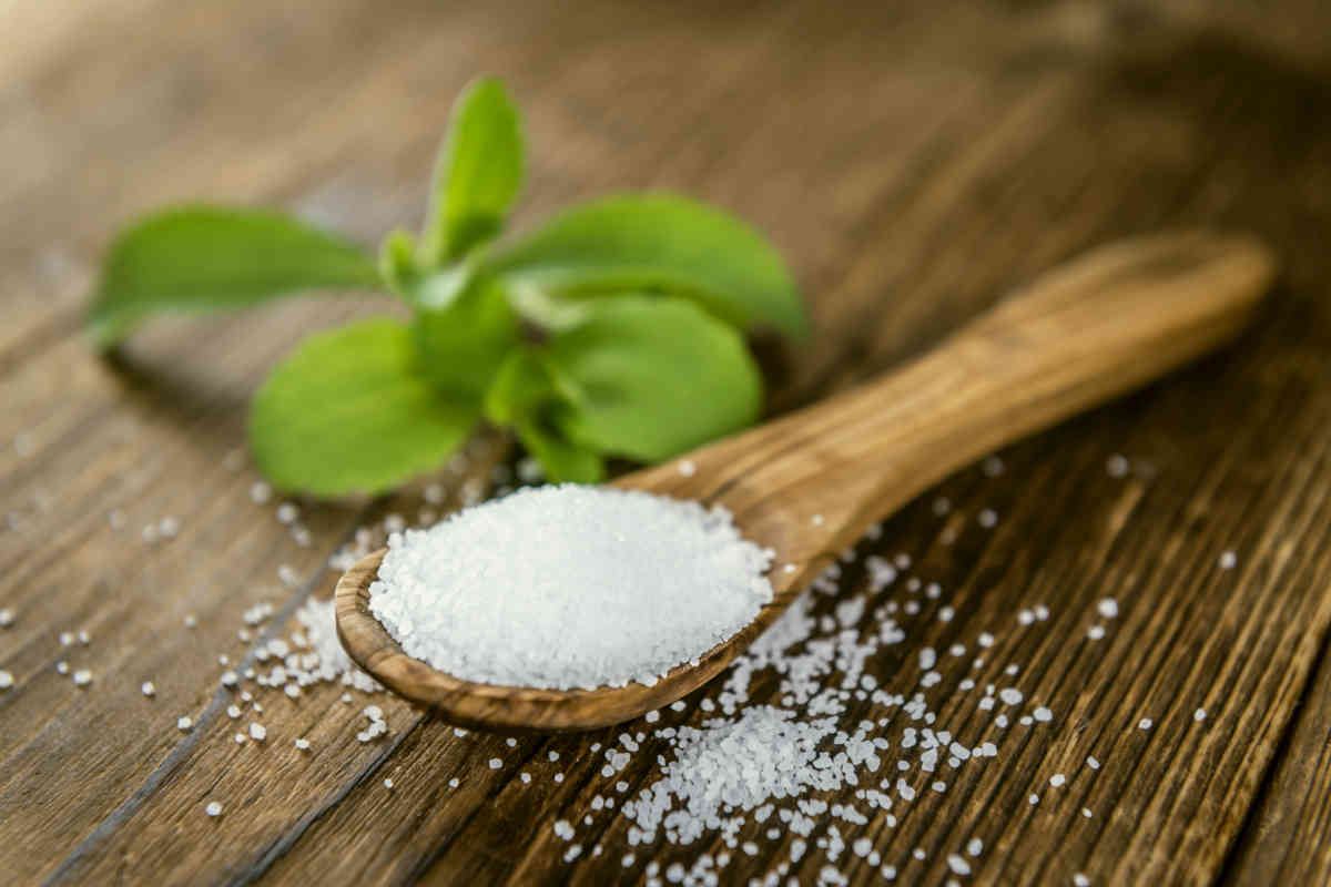 Old wooden table with Stevia Granules | Can Stevia Trigger Fat Storing Hormone?