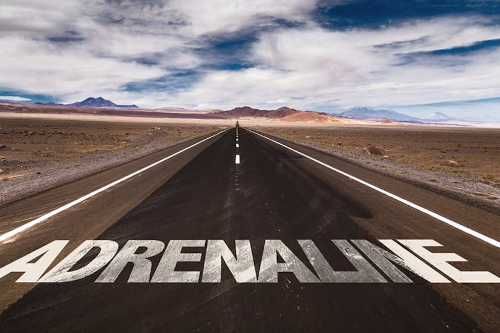 Adrenaline text written on road in the desert. Adrenaline concept.