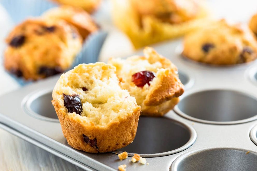 Freshly baked cranberry muffins in a tin muffin pan mold | Guilt-Free Cranberry Pecan Muffins You Can Enjoy This Fall | cranberry muffin recipe