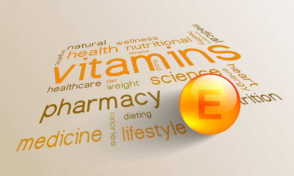 - Vitamin word cloud with vitamin E capsule in front. Words like medicine, lifestyle, health, wellness.