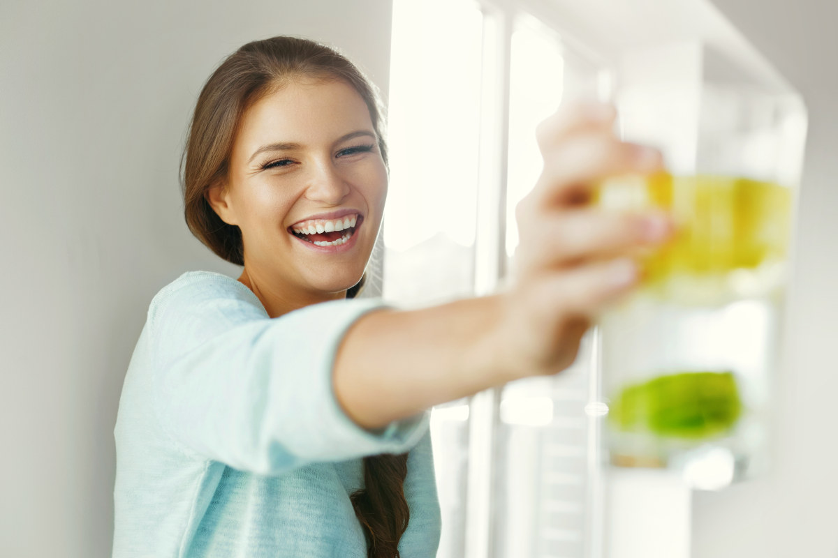 Smiling Woman Drinking Refreshing Water With Fresh Organic Lemon , Lime, Mint | How to Detox GMO Chemicals From Your Body [INFOGRAPHIC]