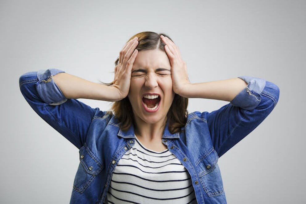 stressed woman with hands on head screaming | Do This for Stress Now