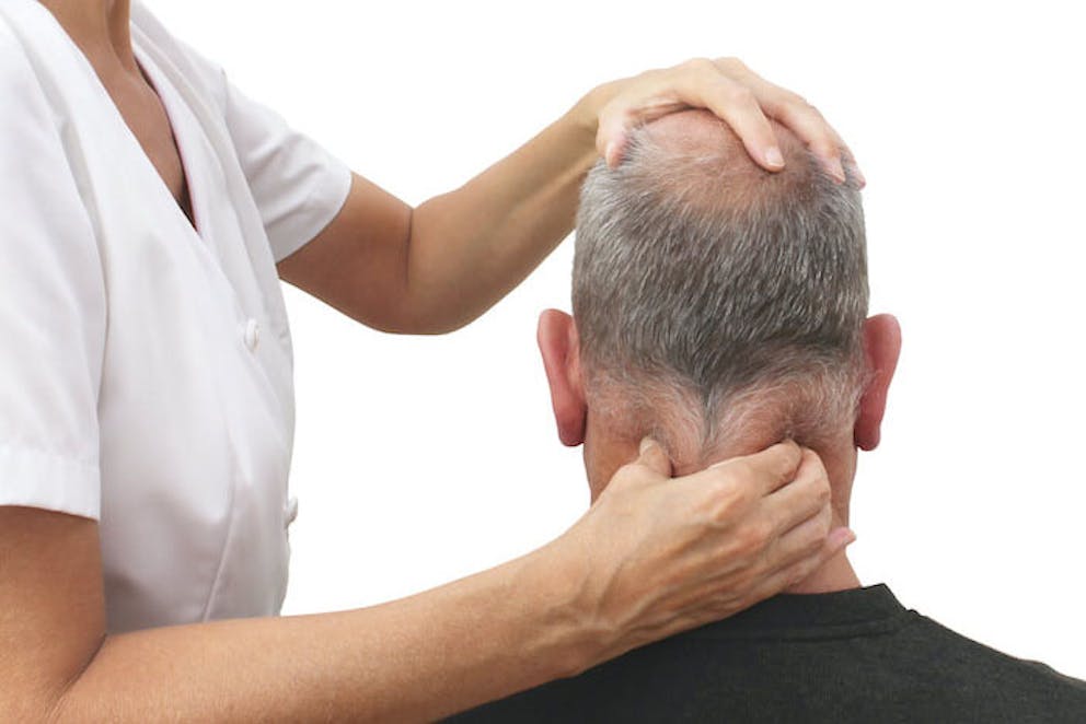 Therapist using acupressure technique for relaxation on back of a man's neck | Do This for Stress Now