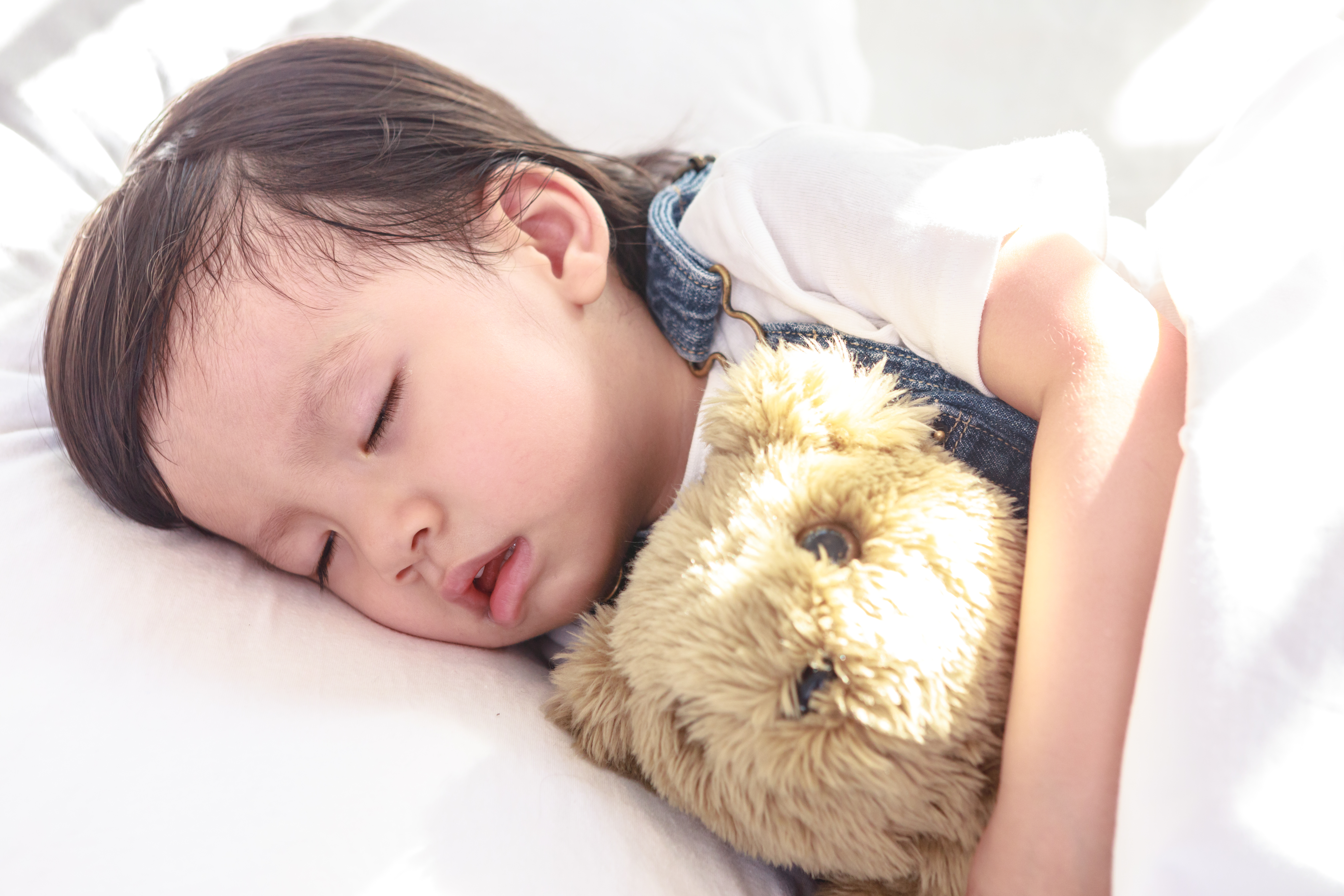 Baby sleeping with teddy bear