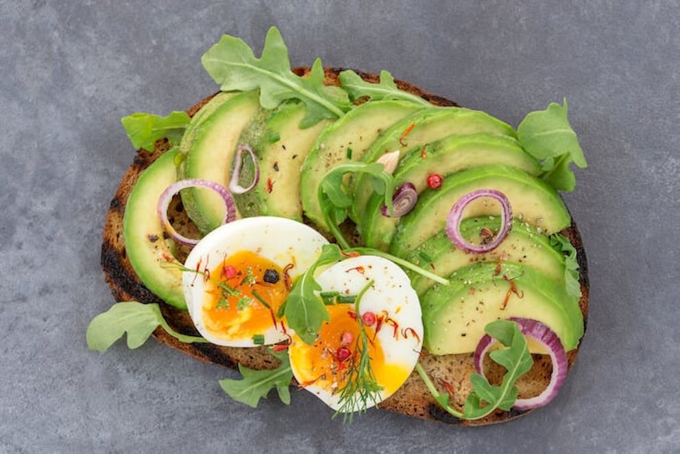 A delicious looking plate of healthy sliced avocados and eggs | Eat Avocados and Eggs for Amazing Hair and Nails