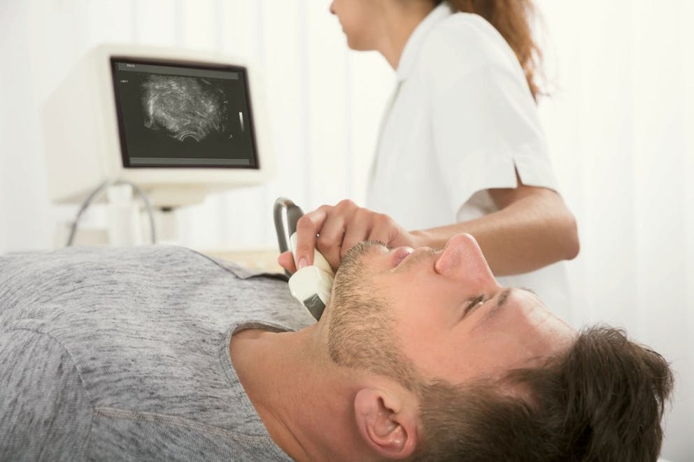 Man Undergoing The Medical Ultrasound Examination In Clinic | Two Causes Of Eye Twitching, Especially Under The Left Eyelid | under left eye twitching