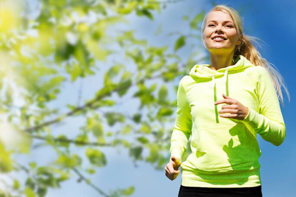 A healthy smiling woman going for a long walk outside in nature | Gaining Weight During Lockdown? Do This!