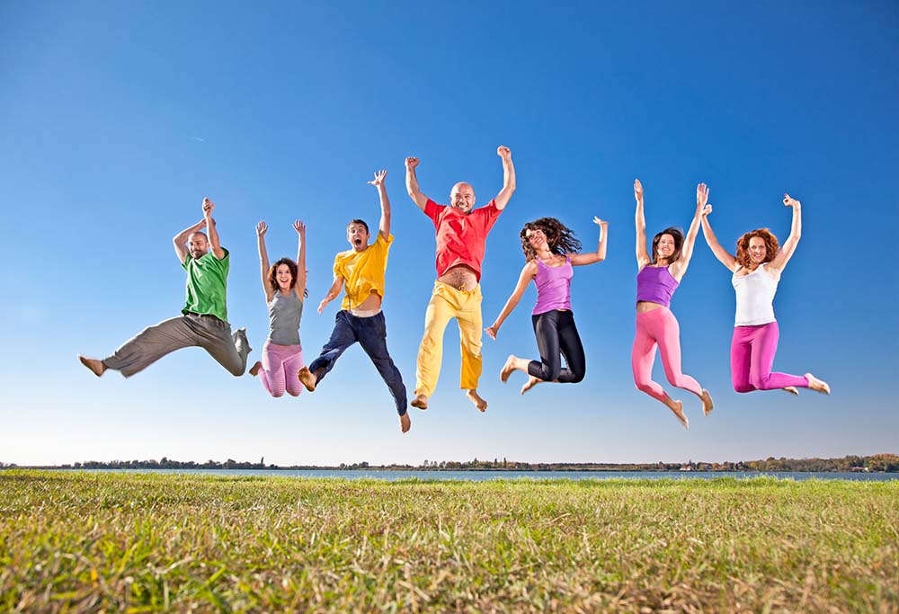 several men and women jumping in the air