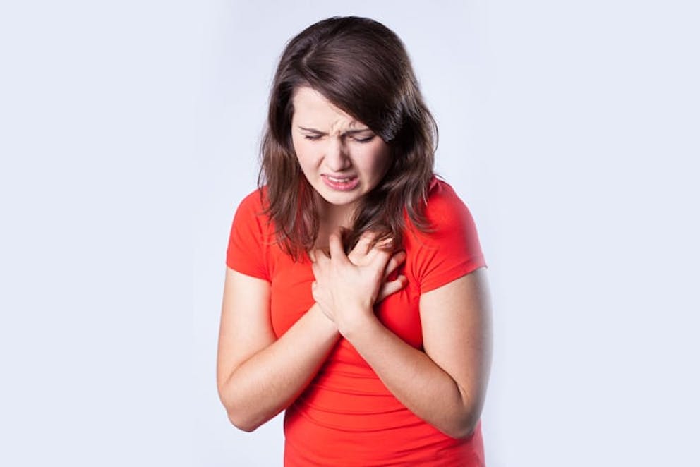 a photo of a woman having chest pain