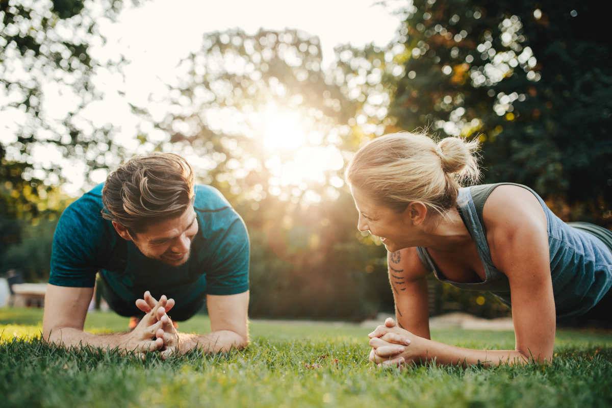Caucasian couple doing core workout together in park | How To Get Rid Of Wrinkles and Reverse Them Effectively