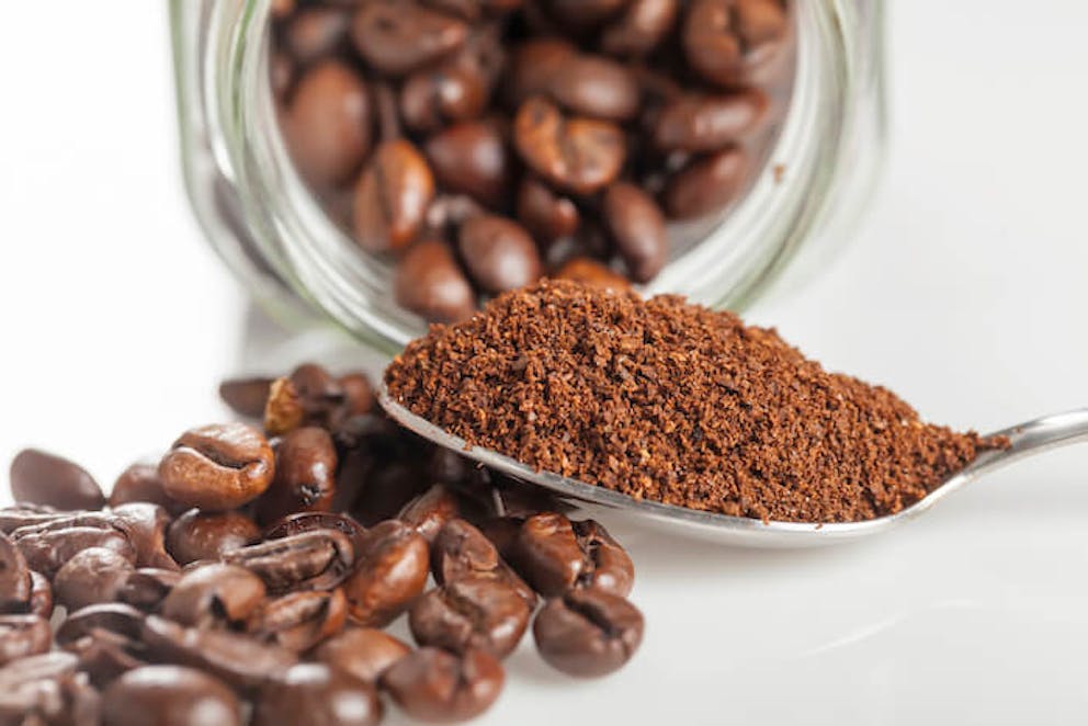 Close up of coffee beans and a spoonful of coffee grounds |  How to Get Rid of Stretch Marks after Pregnancy