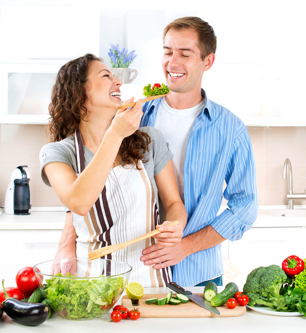 a healthy couple cooking together