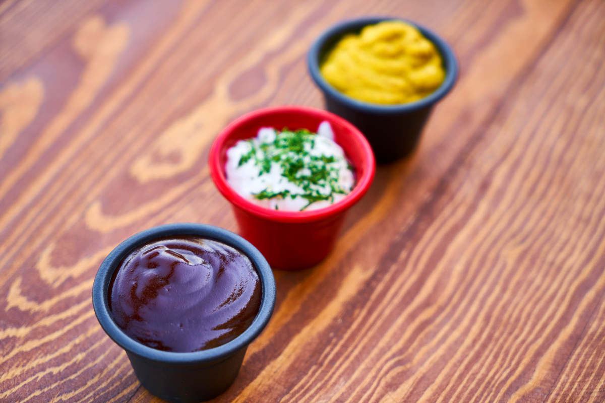 Three Assorted-color of Cream in Containers on Brown Wooden Slab | Grocery Shopping 101: How to Shop at the Grocery Store