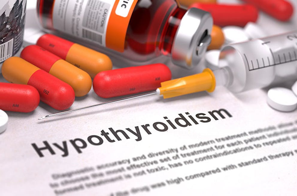 Hypothyroidism medical document with pills, injections, medications around.