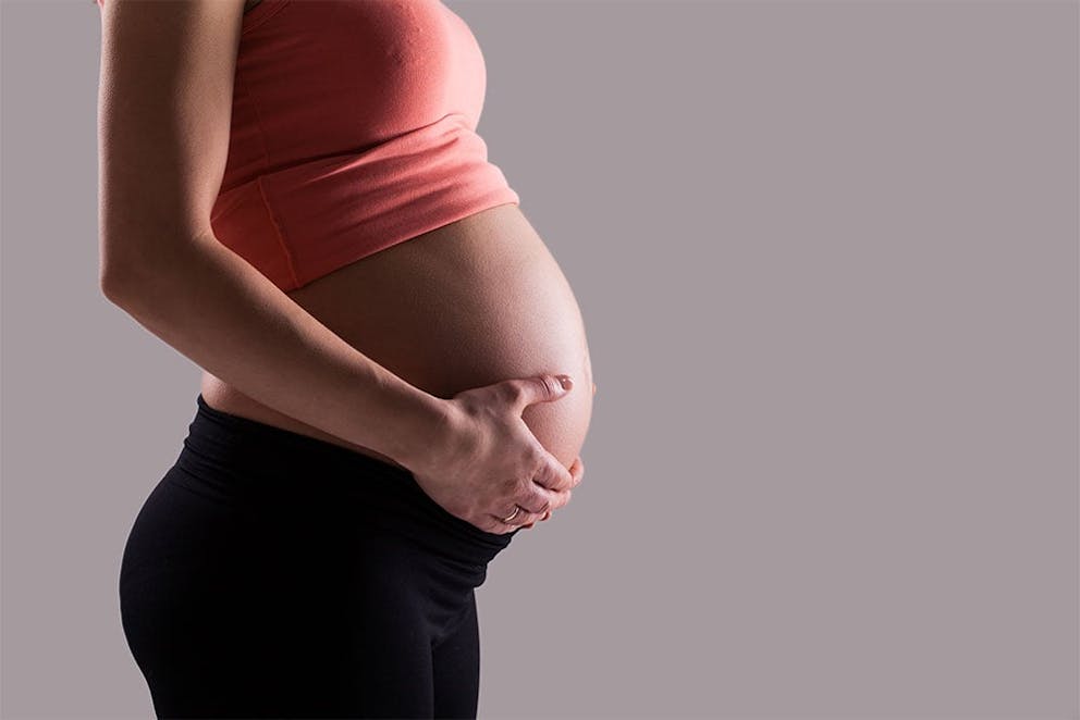 picture of a woman's pregnant belly in profile