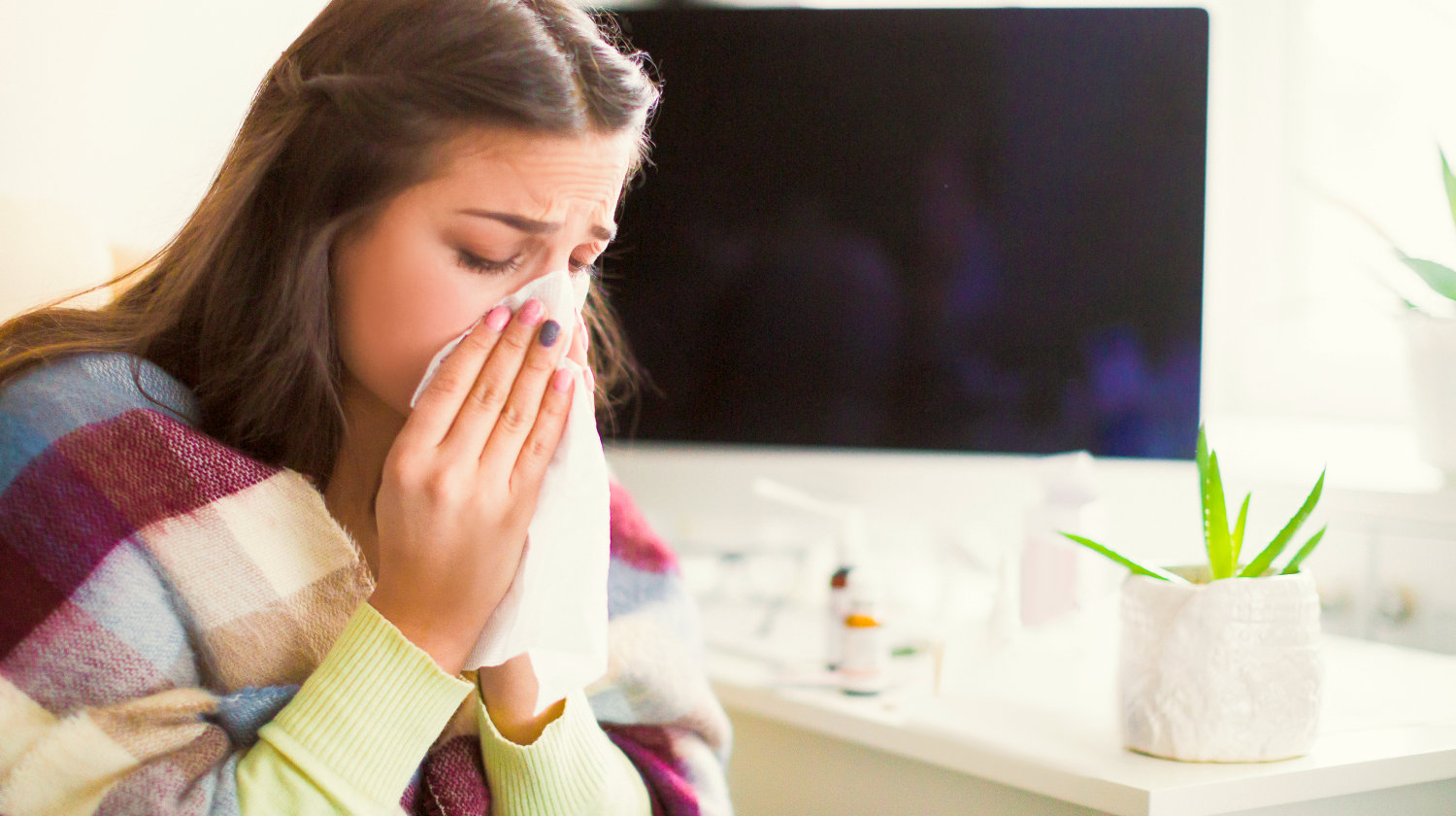 Feature | Side view of the young sick woman who sitting in the office and wiping the snot | Stuck with the Ketogenic Diet Flu? Try These Useful Remedies!