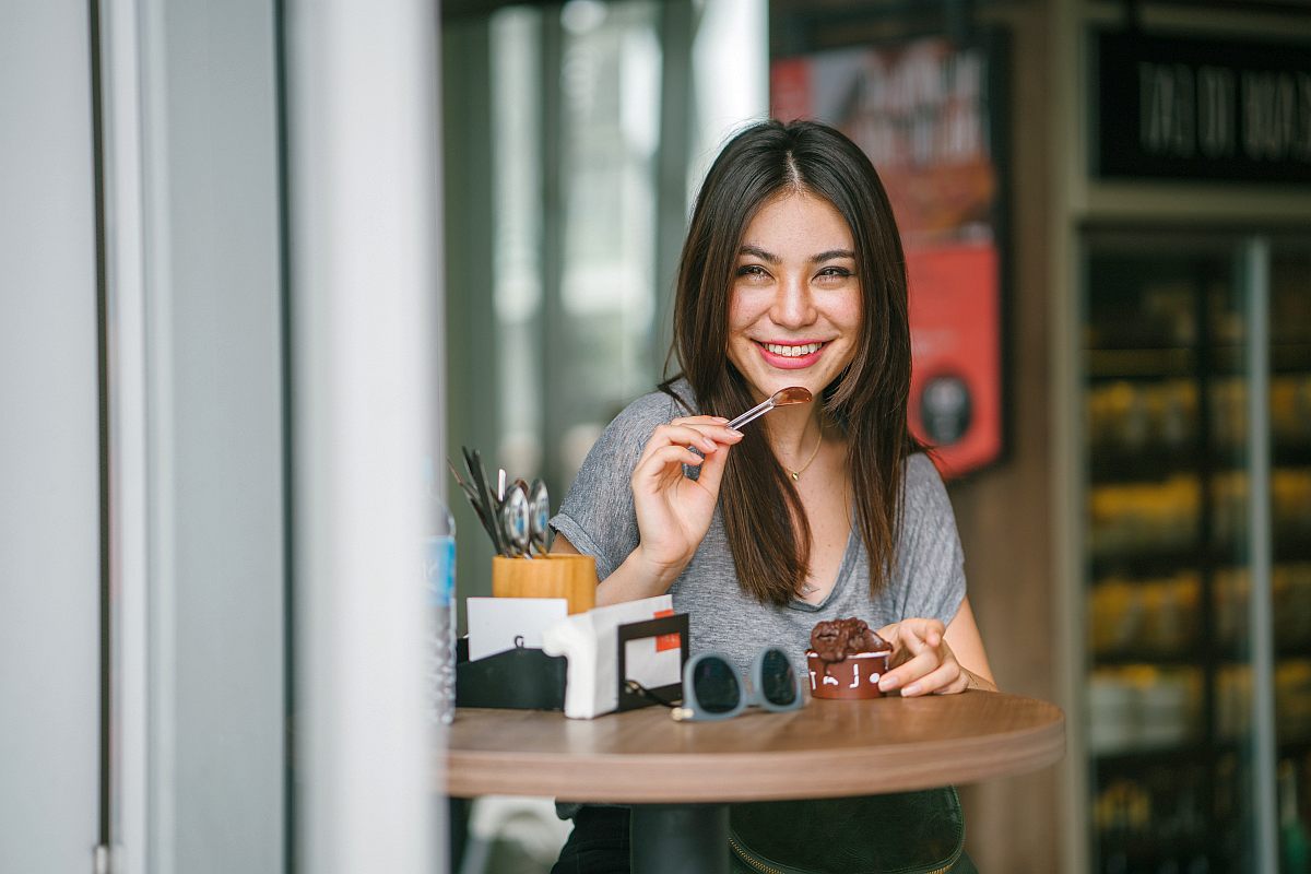 Smiling beautiful woman eating ice cream | Guilt-Free and Keto Friendly Snacks You Should Try