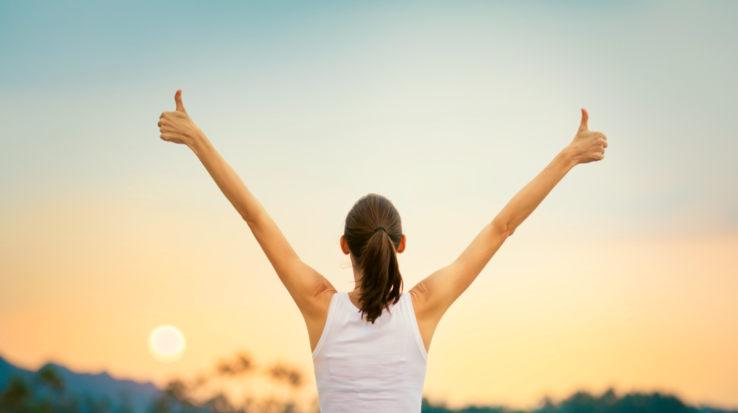 Featured | Young woman with arms in the air giving thumbs up | Understanding The Ketogenic Diet: What Is A Ketone? 