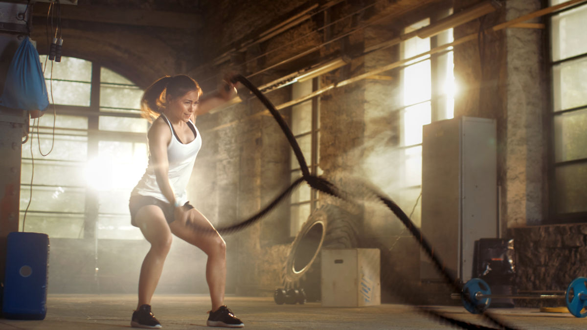 Athletic Female in a Gym Exercises with Battle Ropes | Key Nutrients That Make Your Muscles Grow | Muscle Building Diet
