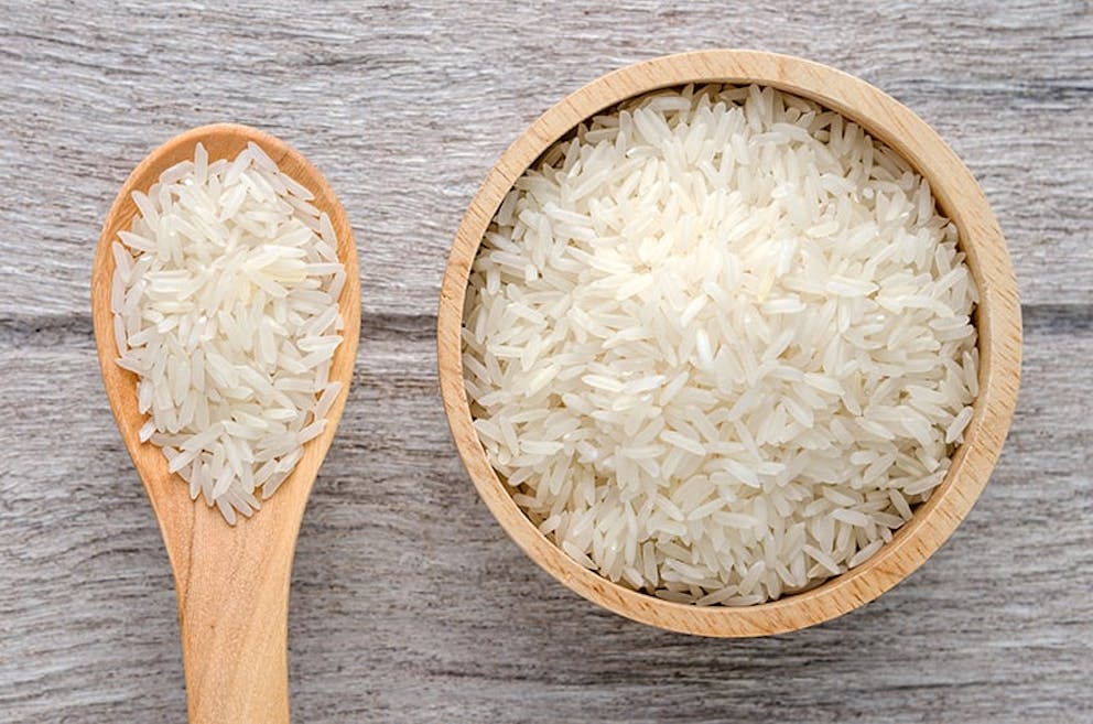 Uncooked rice in a wooden bowl