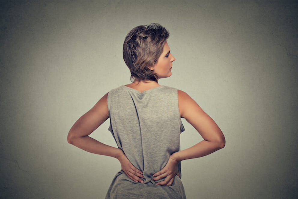 Woman with back, hamstring, and piriformis muscle pain | Yoga for Sciatica Pain