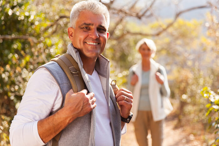 Happy older man going for a hike in the woods with a woman | Natural Remedies for Lyme Disease