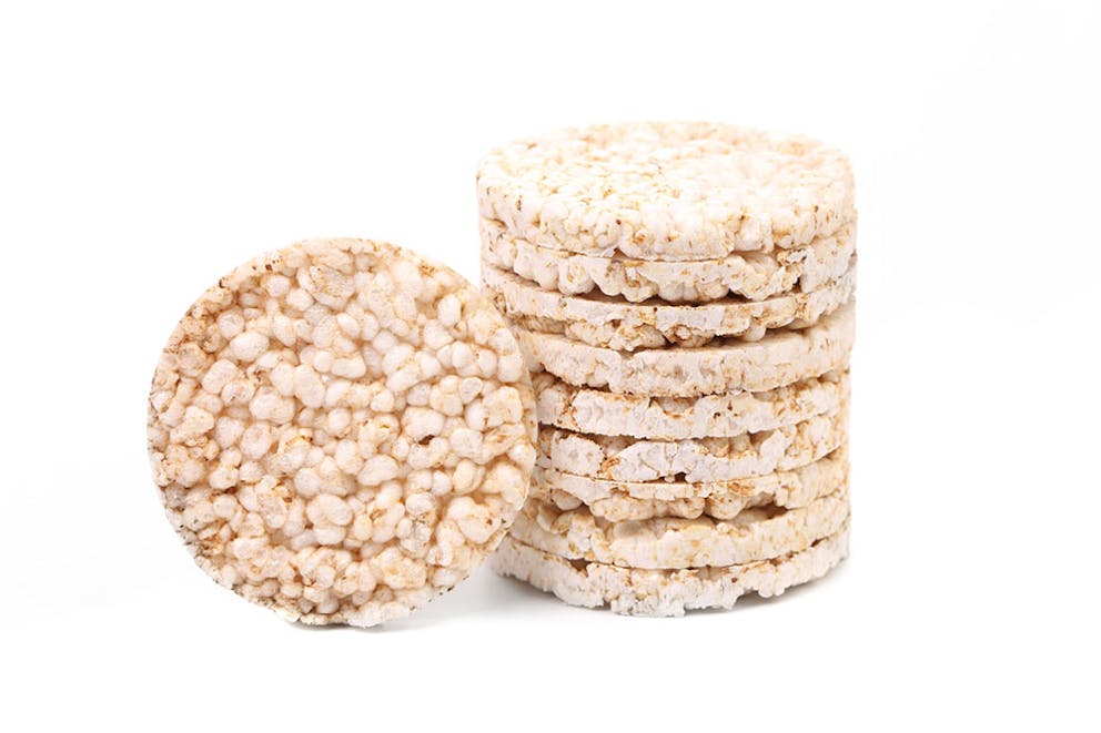 Stack of puffed rice cakes isolated on white background.