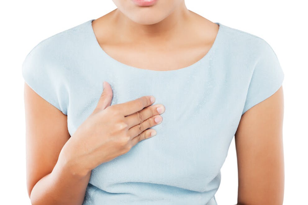 Woman holding chest due to esophagus reflux and esophageal pain | Gastroesophageal Reflux Disease Treatment