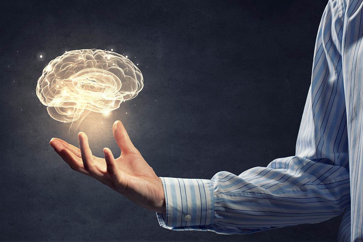 Businessman holding immage of brain | Renew and Protect Your Brain Cells